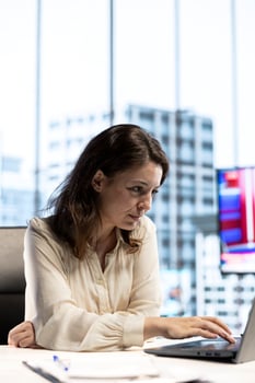Ambitious focused entrepreneur examines enterprise performance metrics, using data driven analytics and reports to make the right decisions that guarantee efficiency and work ethic. photo