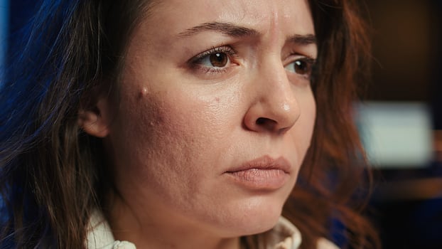 Upset teleworking engineer worried after failing to secure company servers from virus attacks, close up. Anxious woman stressed about being unable to build firewalls protecting data, camera B photo