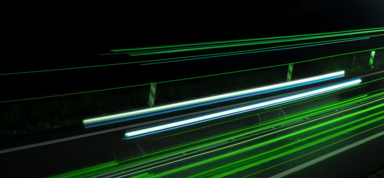 green car lights at night. light line photo