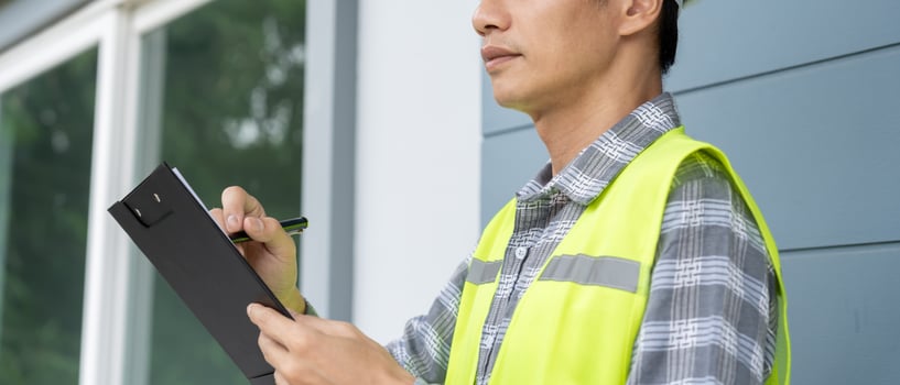 inspector or engineer is inspecting construction and quality assurance new house using a checklist. Engineers or architects or contactor work to build the house photo