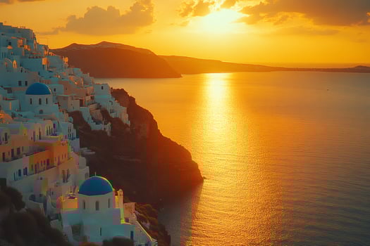 Golden sunset illuminating white houses and blue domed churches of Oia, Santorini, Greece photo