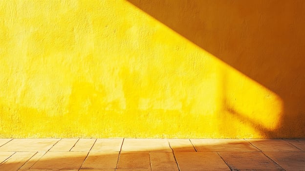 Sunlit yellow wall and tile floor creates a bright and minimalist interior with a geometric light pattern casting shadows on the surfaces. photo