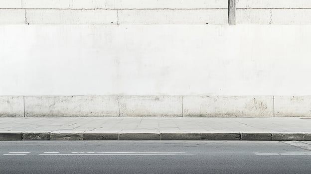 Minimalist street scene with a stark white concrete wall, gray pavement, and black asphalt road. Urban backdrop, neutral, and modern design. photo