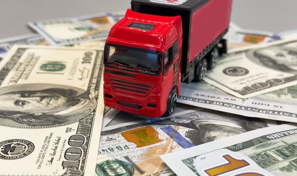 Toy car truck with money isolated on white background photo