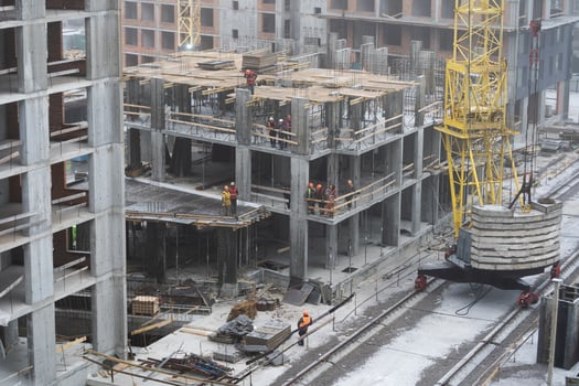 Group of construction engineer team in standard safety uniform work planing in construction site photo