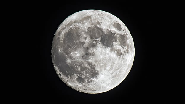 Detailed lunar surface against dark space. The moon's craters and texture are clearly visible, showcasing its celestial beauty. photo