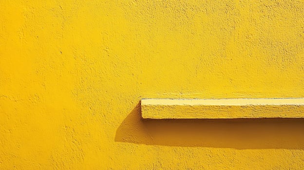 A striking shot of a bright yellow wall featuring a horizontal beam, accentuated by the interplay of light and shadows that create visual interest. photo