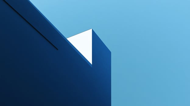 A striking image of geometric blue architecture set against a bright blue sky, highlighting the contrast between structured design and the expanse of nature. photo