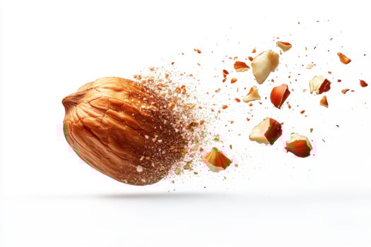 Nuts breaking apart in motion against a plain background photo