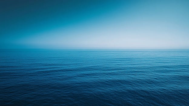 Vast expanse of calm ocean water stretching to the horizon under a gradient blue sky. A scene of tranquility and natural beauty. photo