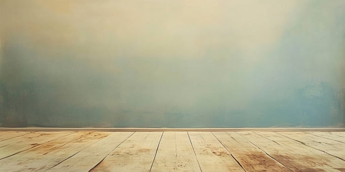 An interior studio view of a room featuring a wooden floor extending to a blue gradient painted wall ideal for product background. photo