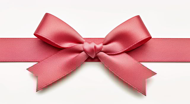 A pink ribbon with a bow on top of it photo