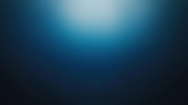 A deep blue background featuring smooth gradients, creating an abstract and tranquil atmosphere that evokes feelings of calmness and introspection. photo