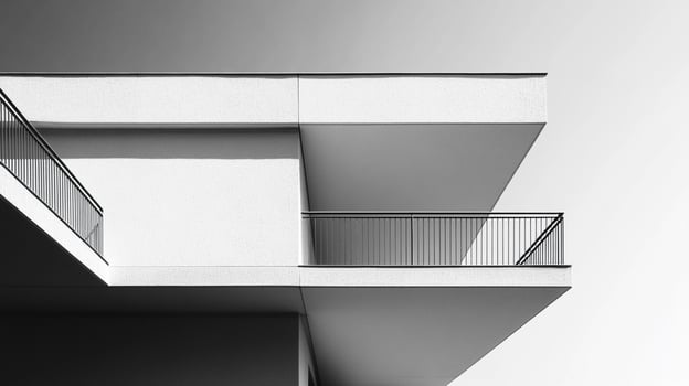 An abstract representation of architectural forms, showcasing overlapping structures and a clean, modern aesthetic against a gradient sky, emphasizing geometric shapes. photo