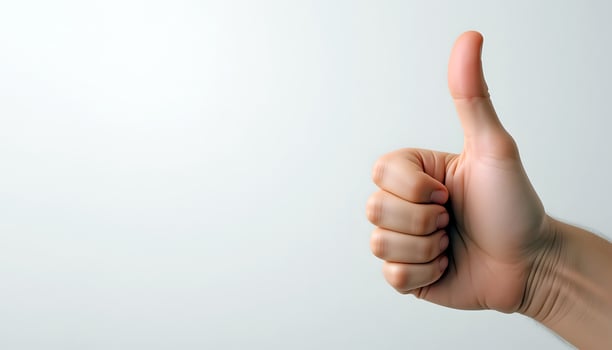 Hand Giving Thumbs-Up Gesture on White Background for Positive Messaging photo
