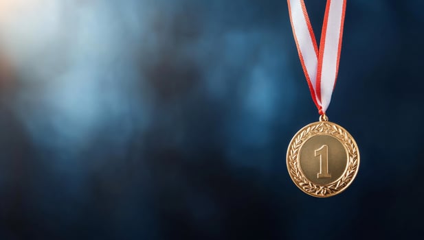 Gold medal on blue background with copy space photo