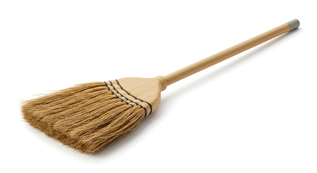 A broom with a wooden handle on a white background photo