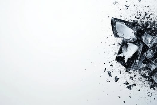 Shattered glass pieces scattered on a white surface photo
