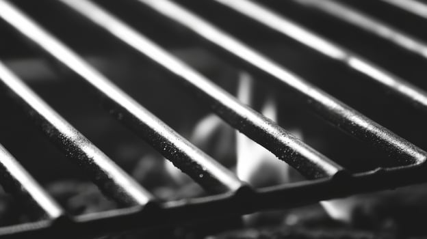 Flames dance under a grilling surface at an outdoor barbecue photo