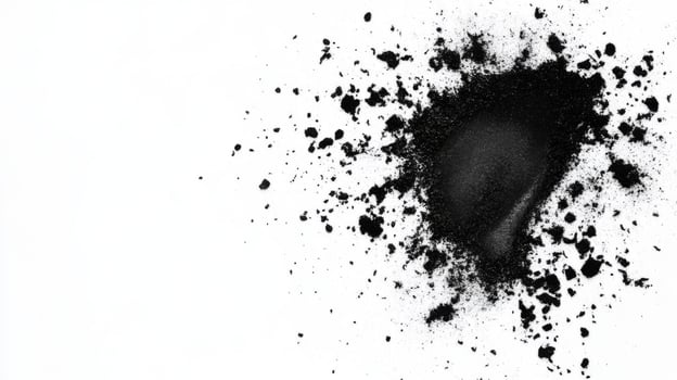 Black powder spreads across a white surface creating texture photo