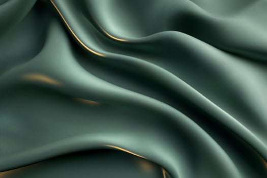 A close-up of soft, flowing green fabric with subtle light reflections. photo