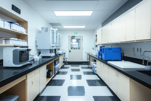A large, clean, and well-lit laboratory with a counter and a sink photo