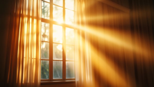 Sunlight streaming through a window with sheer curtains. photo