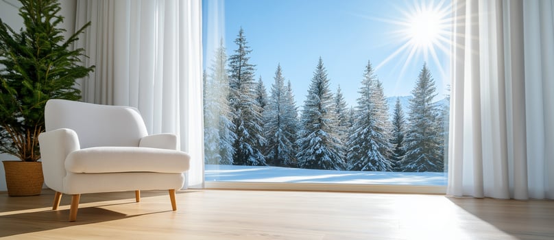 bright and modern interior featuring white armchair, large windows, and stunning view of snow covered trees. sunlight streams in, creating warm and inviting atmosphere photo