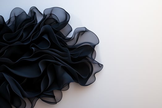 flowing black fabric with soft, ruffled textures creates elegant and dynamic visual. delicate layers evoke sense of movement and sophistication photo