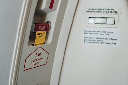 a closed Passenger airplane entrance door - inside view - with the inflatable emergency evacuation slide in armed position - door 1L photo