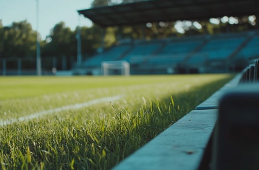 A classic football field with freshly painted lines and goalposts standing tall. The lush green grass and clear sky create the perfect setting for game day and sports-related projects photo