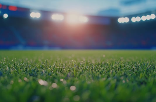 A brightly lit football field at night, with powerful floodlights illuminating the turf. A perfect image for night games, stadium excitement, and competitive sports themes photo