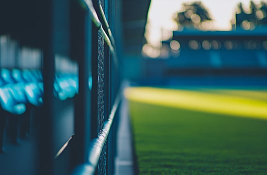 A well-maintained football field with bright stadium lights shining over the green turf. Ideal for sports photography, training visuals, and energetic football-themed projects photo