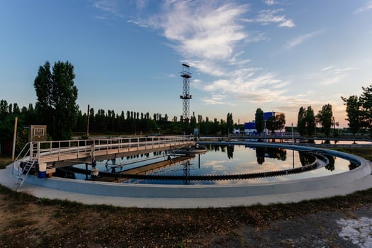 Modern sewage treatment plant. Round wastewater purification tanks at sunset. photo