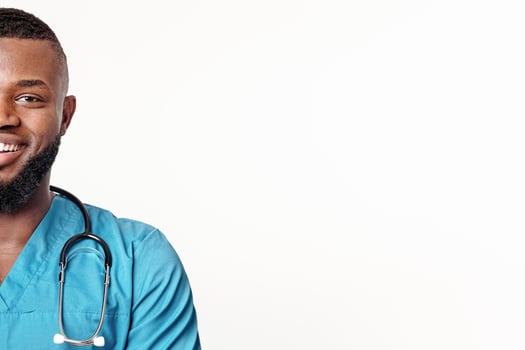Visit new modern clinic. Close up portrait of smiling african american doctor over white studio background, panorama with empty space photo