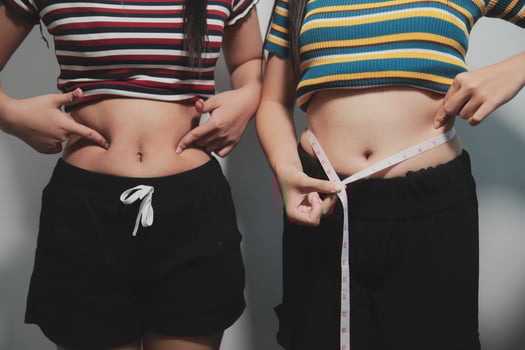 Two women with their stomachs measured photo