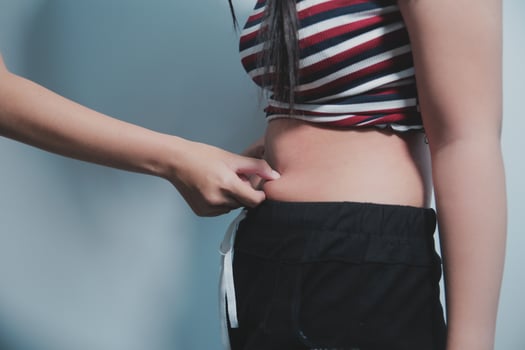 A woman is holding her stomach with her hands photo
