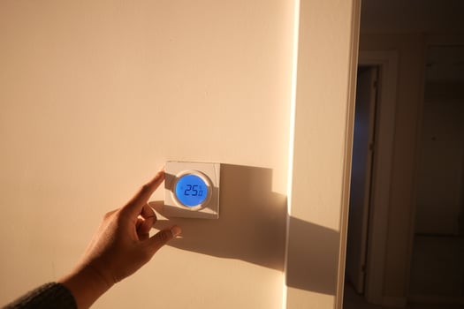 Setting the temperature on a thermostat in a bright room photo