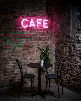 Cozy cafe interior with neon sign and table for two photo