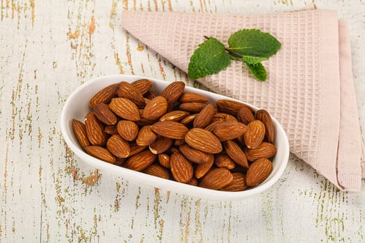 Almonds in a bowl on a wooden table photo
