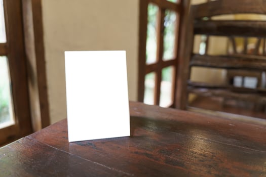 Menu mock up blank for text marketing promotion. Mock up Menu frame standing on wood table in restaurant space for text photo