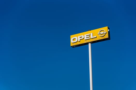 Prague, Czech Republic - September 20, 2024. Opel dealership sign on a tall pole, a clear blue sky photo