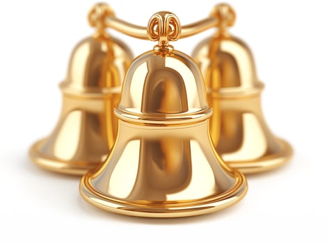 A close-up of three shiny golden bells, artistically arranged, exuding a festive mood. photo