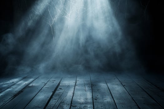 A dimly lit space with beams of light and a smoky atmosphere. photo