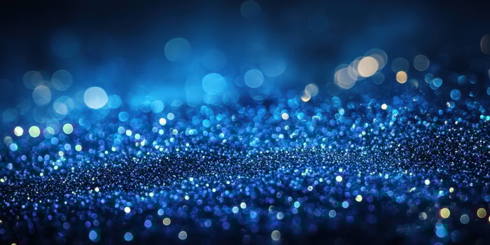 Captivating blue glitter sparkles create a mesmerizing atmosphere during a night celebration or artistic event photo