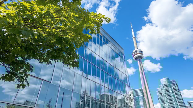 Cityscape featuring a modern building and a tower under a blue sky. photo