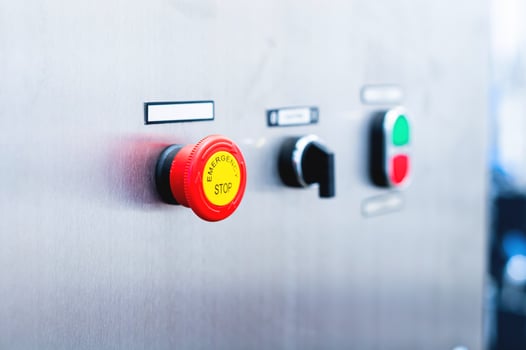 A red Emergency STOP button used for safety on industrial equipment, machine machinery electrical system emergency shutdown mechanism, nuclear power plant, factory, workers safety security concept photo