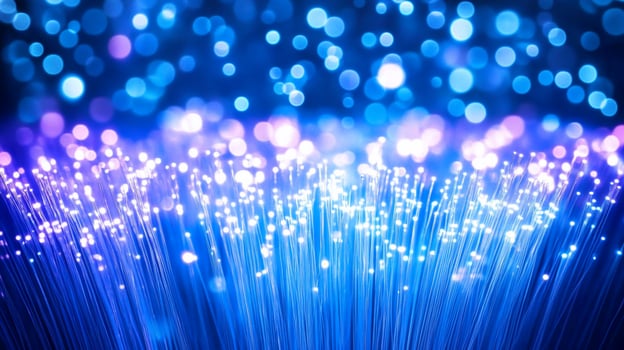 A vibrant display of glowing fiber optic strands against a blue backdrop. photo