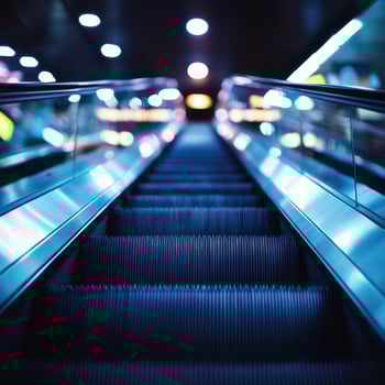 Escalator rising in a modern urban setting during the evening with soft lighting and vibrant colors photo