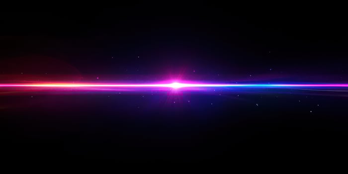 Colorful light streaks creating a vibrant cosmic atmosphere in a dark backdrop during nighttime photo